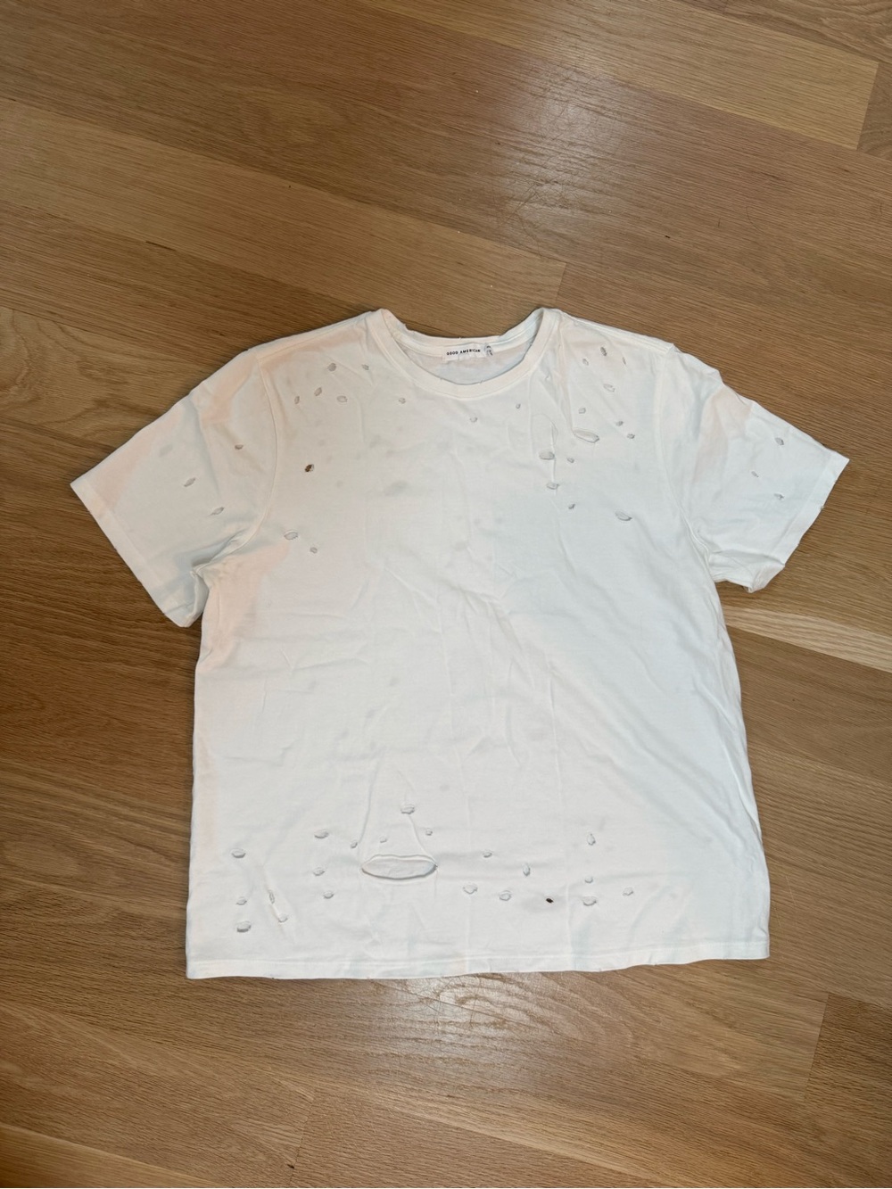 Good American women’s distressed white T shirt.